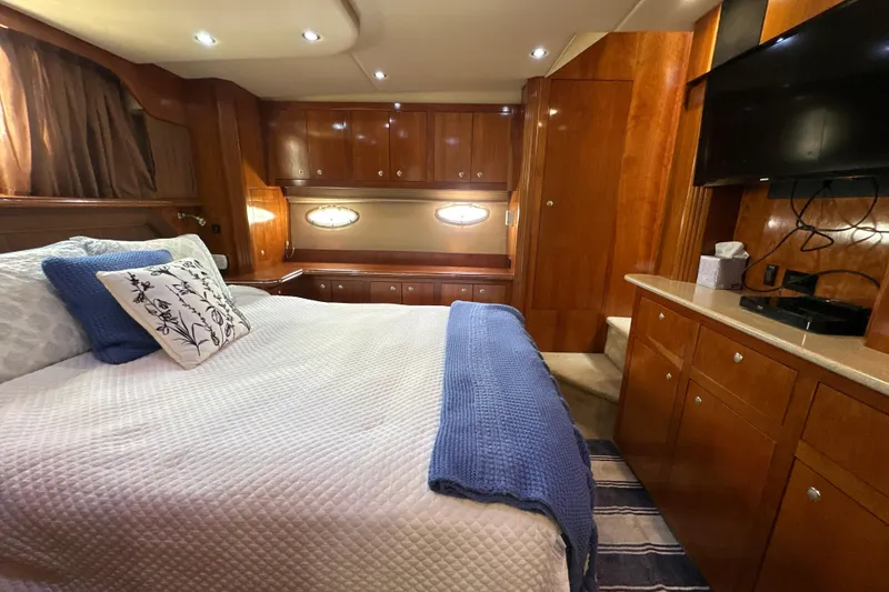 Slide: The Image of Luxurious 2004 Cruisers Yachts 405 Express Motoryacht bedroom with elegant wood cabinetry. - 85