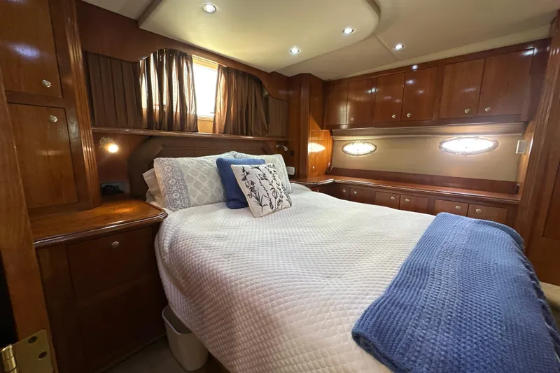 Slide: The Image of Luxurious cabin interior of 2004 Cruisers Yachts 405 Express Motoryacht with cozy bed and wood finish. - 86