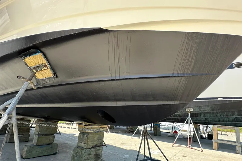 Slide: The Image of 2004 Cruisers Yachts 405 Express Motoryacht hull on dry dock, supported by blocks. - 95