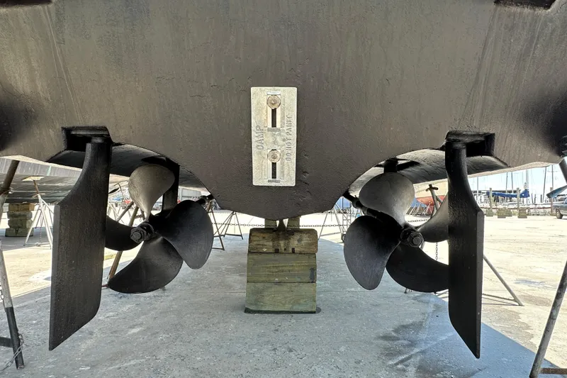 Slide: The Image of 2004 Cruisers Yachts 405 Express Motoryacht propellers and rudders in dry dock. - 96