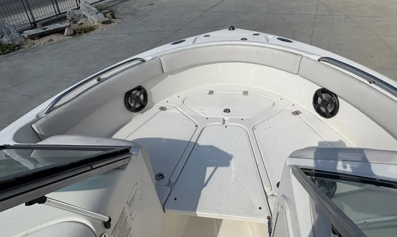 Slide: The Image of 2006 Robalo R227 Dual Console boat interior with spacious seating and speakers. - 11