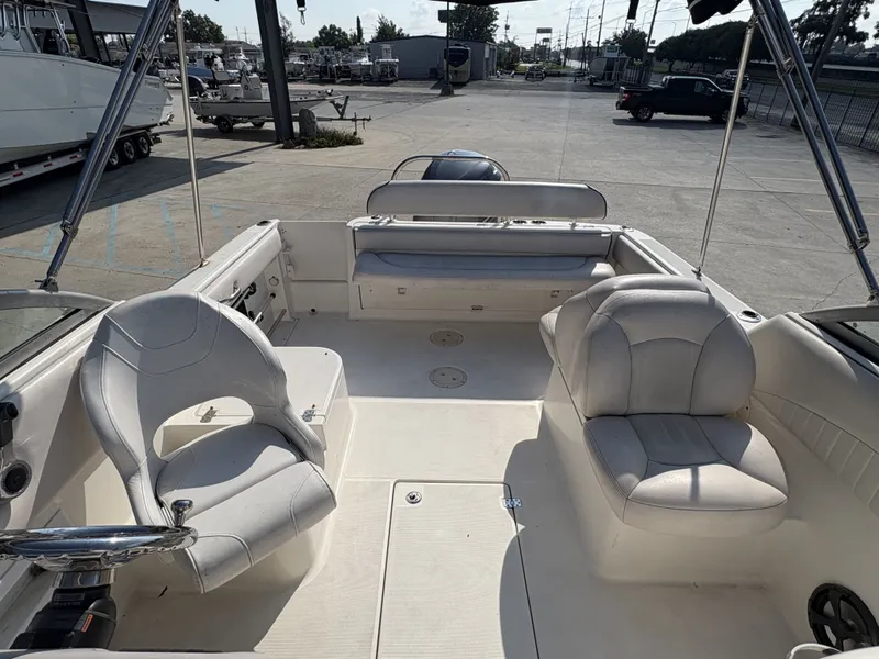Slide: The Image of 2006 Robalo R227 Dual Console boat interior with seating and steering wheel. - 4