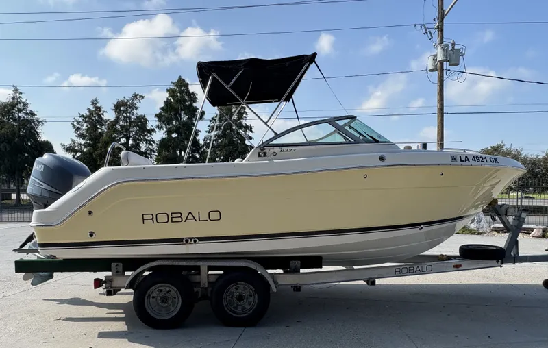 Slide: The Image of 2006 Robalo R227 Dual Console boat on trailer, side view, outdoors. - 8