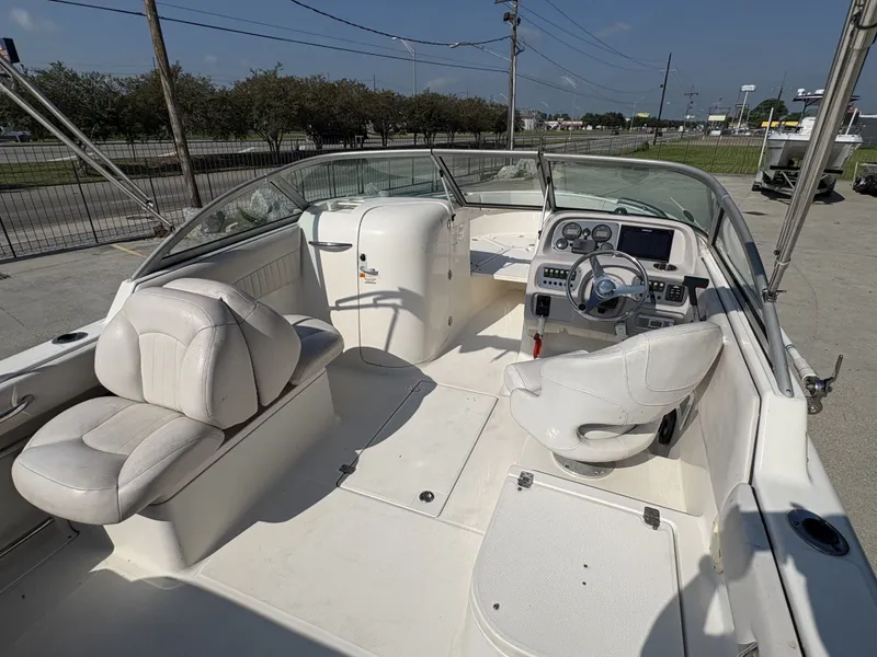 Slide: The Image of 2006 Robalo R227 Dual Console boat interior with steering wheel and seating. - 9