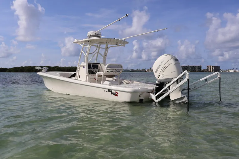 The Image of 2019 SeaVee 270Z boat in clear water, featuring a powerful outboard motor. - 0
