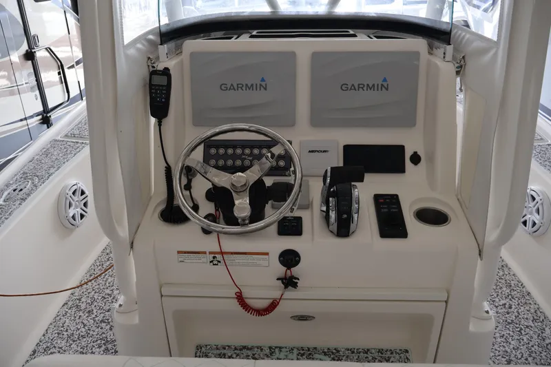 Slide: The Image of 2019 SeaVee 270Z boat helm with Garmin displays and Mercury controls. - 10