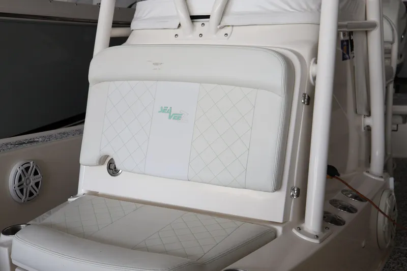Slide: The Image of 2019 SeaVee 270Z boat interior with white cushioned seating and speaker detail. - 17