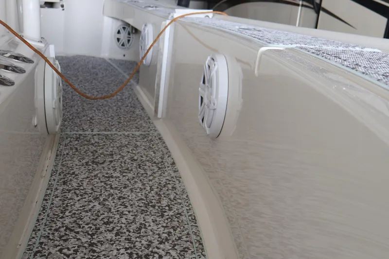 Slide: The Image of 2019 SeaVee 270Z boat interior with speakers and textured flooring. - 18