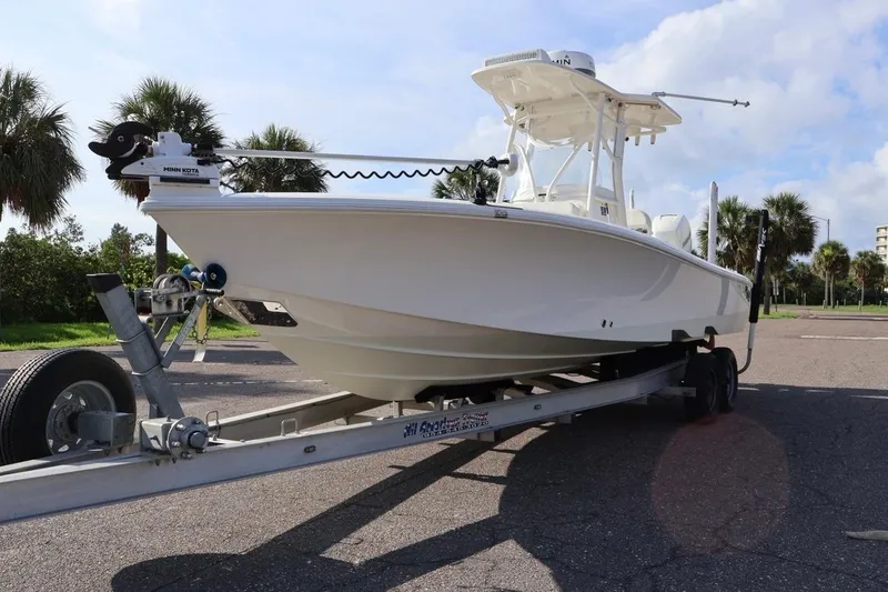 Slide: The Image of 2019 SeaVee 270Z boat on trailer, parked outdoors with palm trees in background. - 21
