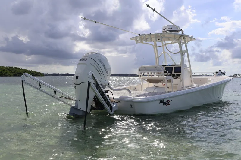 Slide: The Image of 2019 SeaVee 270Z boat anchored in shallow water under a cloudy sky. - 4