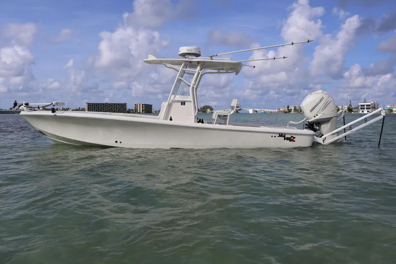Slide: The Image of 2019 SeaVee 270Z boat on water, clear sky, coastal background. - 5