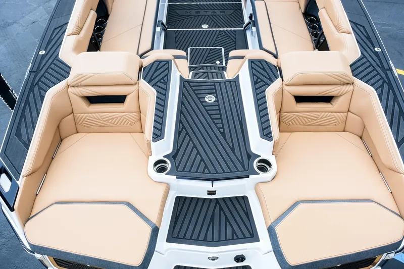 Slide: The Image of 2026 MasterCraft XStar 25 boat interior with tan seating and black accents. - 12