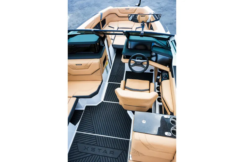 Slide: The Image of 2026 MasterCraft XStar 25 interior with luxurious tan seating and modern dashboard design. - 14