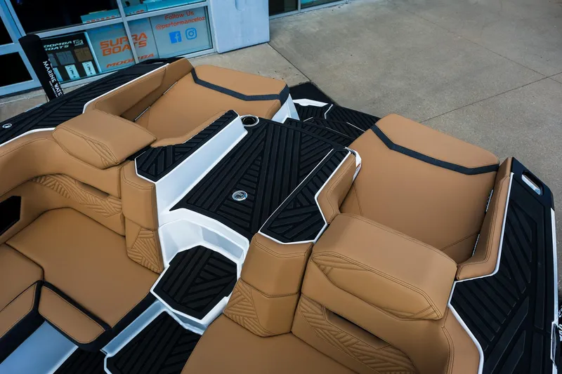 Slide: The Image of 2026 MasterCraft XStar 25 boat interior with tan seating and black accents. - 19