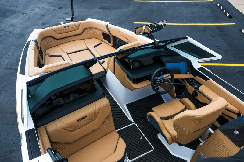Slide: The Image of 2026 MasterCraft XStar 25 boat interior with luxurious tan seating and modern dashboard. - 20