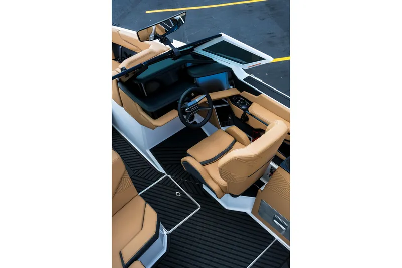 Slide: The Image of 2026 MasterCraft XStar 25 interior with tan leather seats and modern dashboard design. - 21