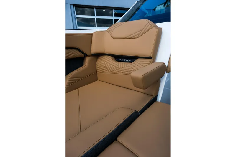 Slide: The Image of Luxurious tan seating in 2026 MasterCraft XStar 25 boat interior. - 24