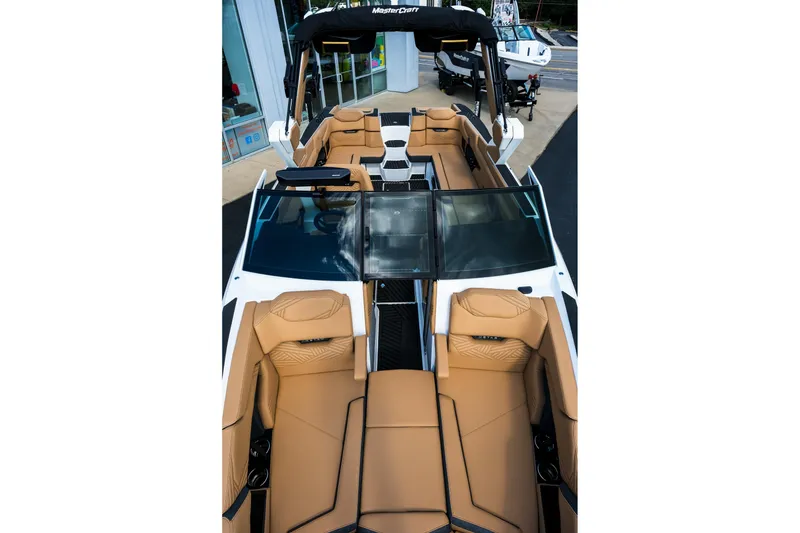 Slide: The Image of 2026 MasterCraft XStar 25 boat interior with tan leather seating and sleek design. - 27