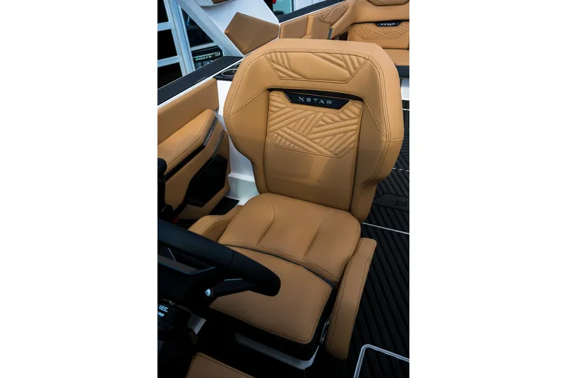 Slide: The Image of Luxurious tan leather seat in 2026 MasterCraft XStar 25 boat interior. - 29