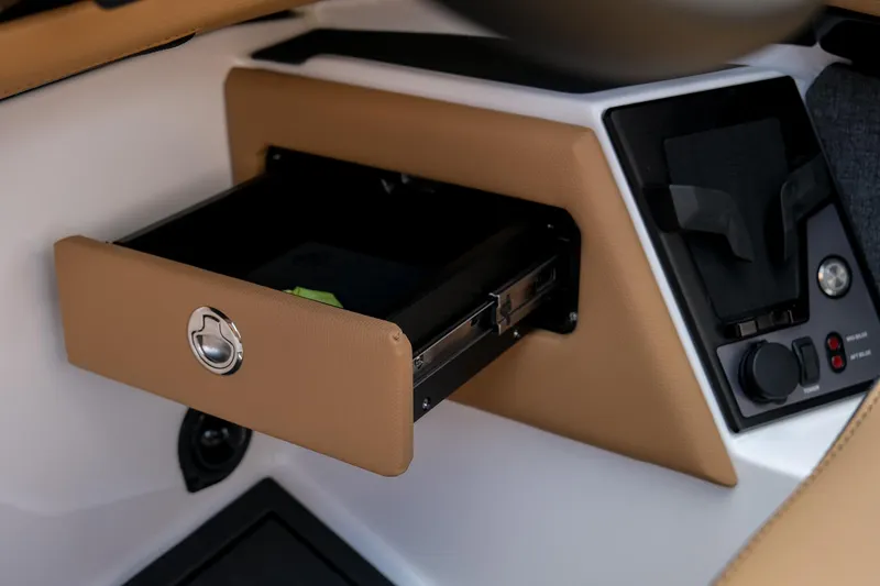 Slide: The Image of 2026 MasterCraft XStar 25 boat interior with open storage compartment and control panel. - 32