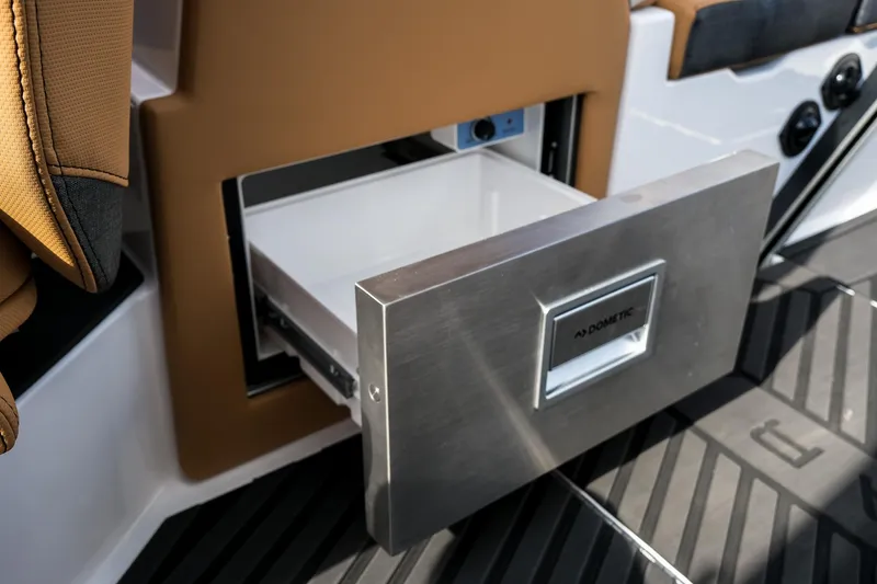 Slide: The Image of 2026 MasterCraft XStar 25 boat with open Dometic drawer refrigerator. - 34