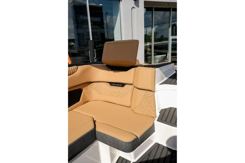 Slide: The Image of 2026 MasterCraft XStar 25 boat interior with tan seating and modern design. - 38