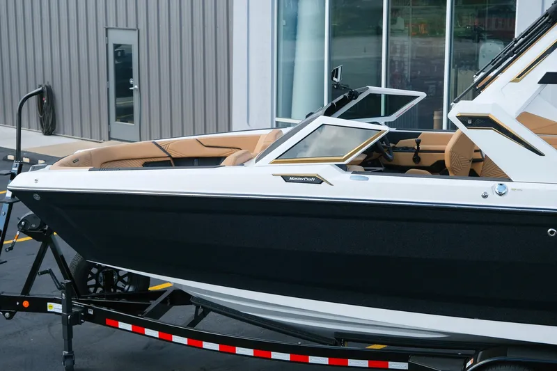 Slide: The Image of 2026 MasterCraft XStar 25 boat with sleek design and luxurious interior on trailer. - 4