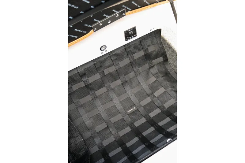 Slide: The Image of Interior detail of 2026 MasterCraft XStar 25 boat, featuring black woven material. - 40