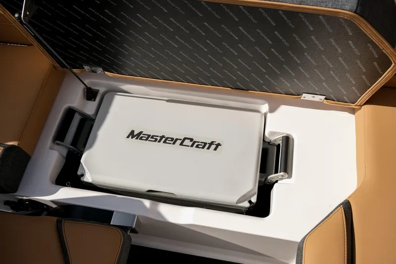 Slide: The Image of 2026 MasterCraft XStar 25 boat storage compartment with branded cooler. - 41