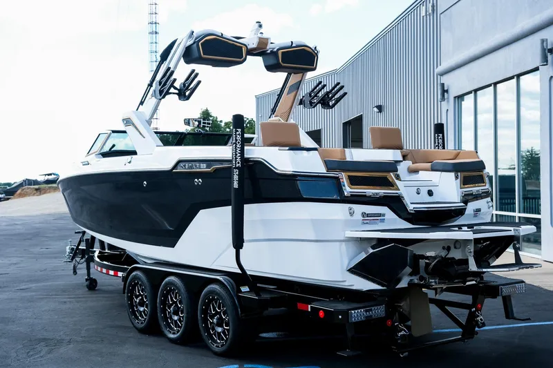 Slide: The Image of 2026 MasterCraft XStar 25 boat on trailer, sleek design, black and white exterior. - 7