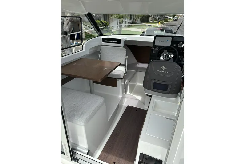 Slide: The Image of 2023 Jeanneau NC Weekender 695 Series 2 interior with seating and navigation console. - 13