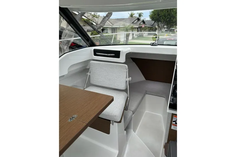 Slide: The Image of 2023 Jeanneau NC Weekender 695 Series 2 interior with seating and table. - 15