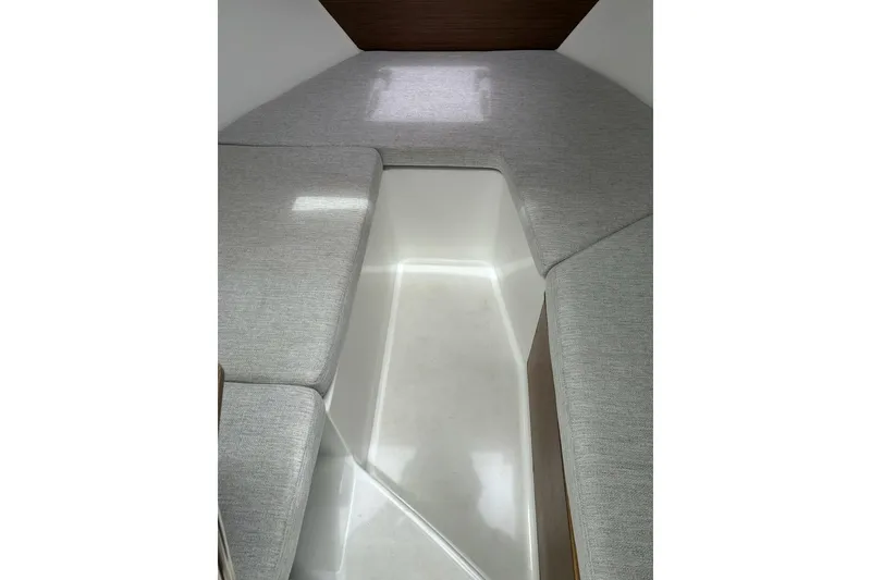 Slide: The Image of 2023 Jeanneau NC Weekender 695 Series 2 interior cabin with gray cushions. - 25