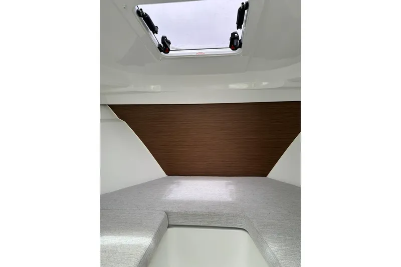 Slide: The Image of Interior cabin of 2023 Jeanneau NC Weekender 695 Series 2 with skylight and cushioned seating. - 26
