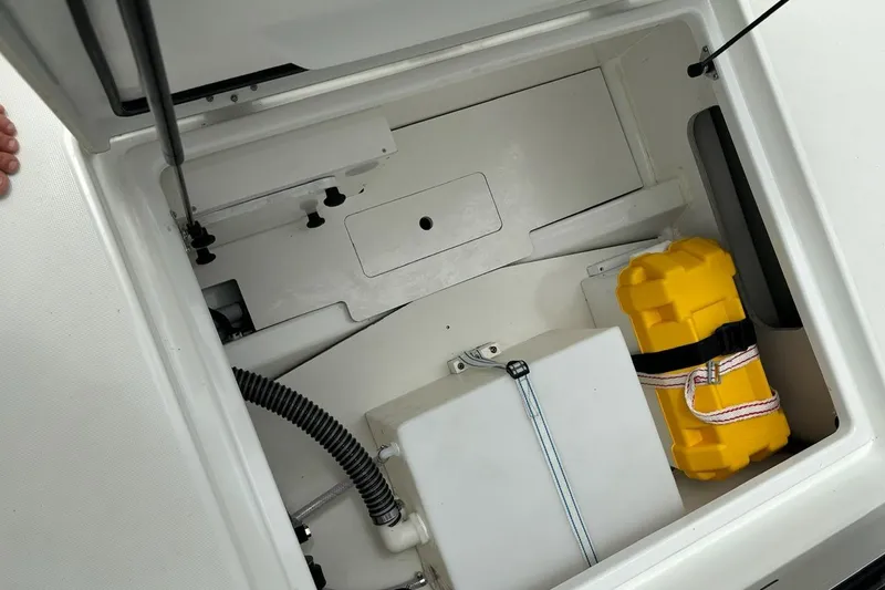 Slide: The Image of Storage compartment of 2023 Jeanneau NC Weekender 695 Series 2 with yellow safety equipment. - 28