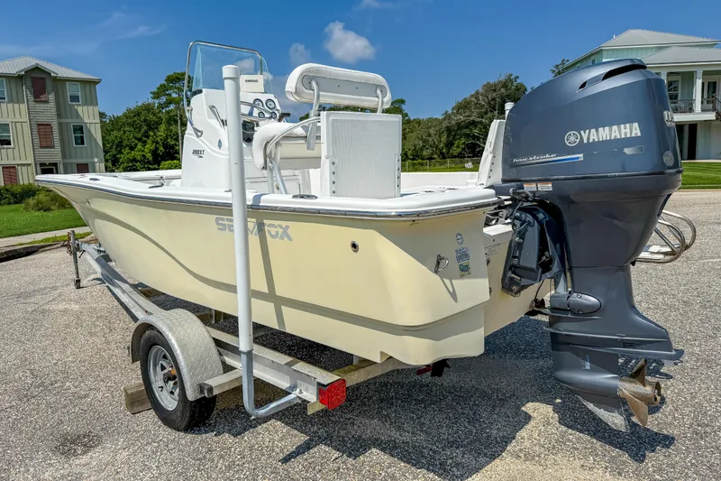 Slide: The Image of 2013 Sea Fox 200XT boat with Yamaha engine on trailer, parked near houses. - 10