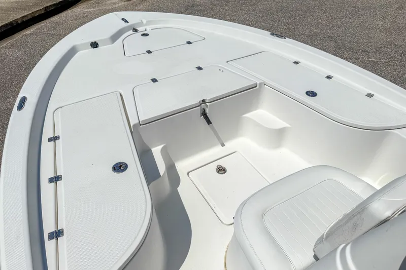 Slide: The Image of 2013 Sea Fox 200XT boat interior with white seating and storage compartments. - 11