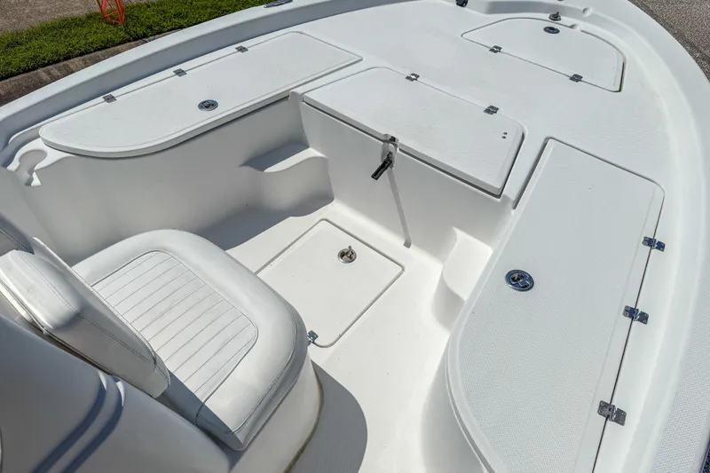 Slide: The Image of 2013 Sea Fox 200XT boat interior with white seating and storage compartments. - 13