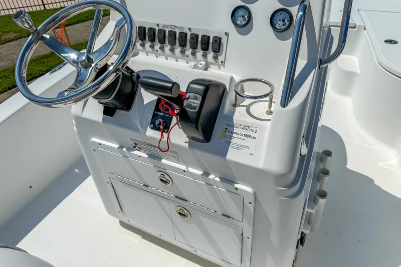 Slide: The Image of 2013 Sea Fox 200XT boat console with steering wheel, gauges, and controls. - 14