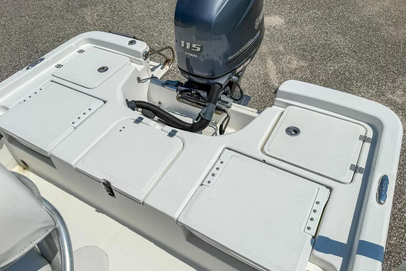 Slide: The Image of 2013 Sea Fox 200XT boat with Yamaha 115 engine, featuring storage compartments. - 19