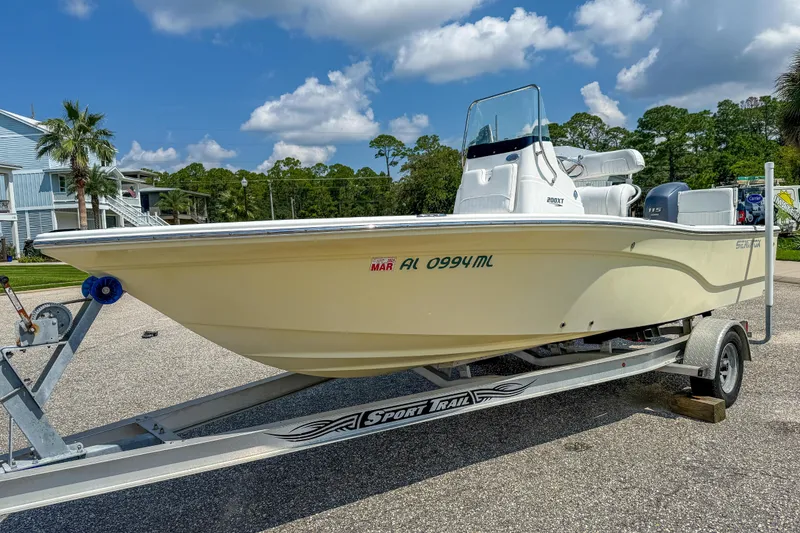 Slide: The Image of 2013 Sea Fox 200XT boat on trailer, parked outdoors under a blue sky. - 2