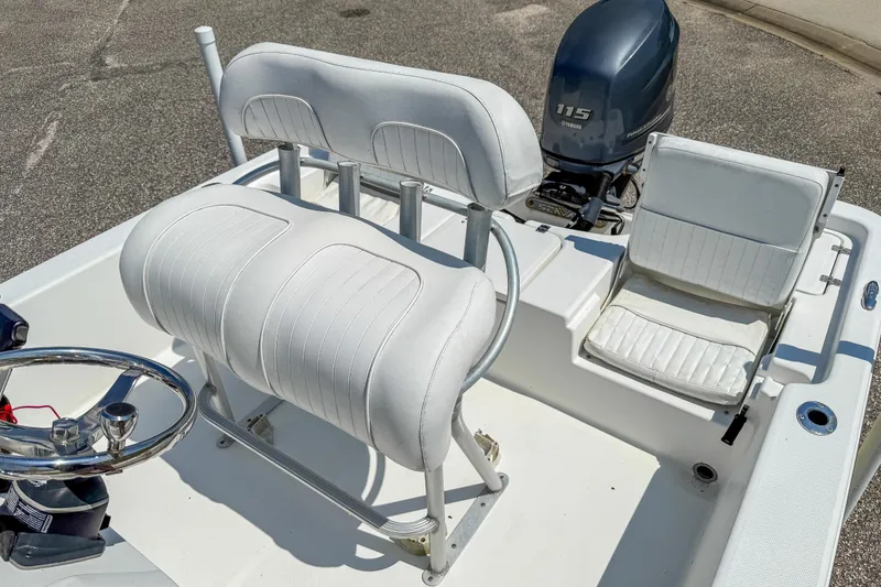Slide: The Image of 2013 Sea Fox 200XT boat interior with white seating and Yamaha 115 outboard motor. - 20