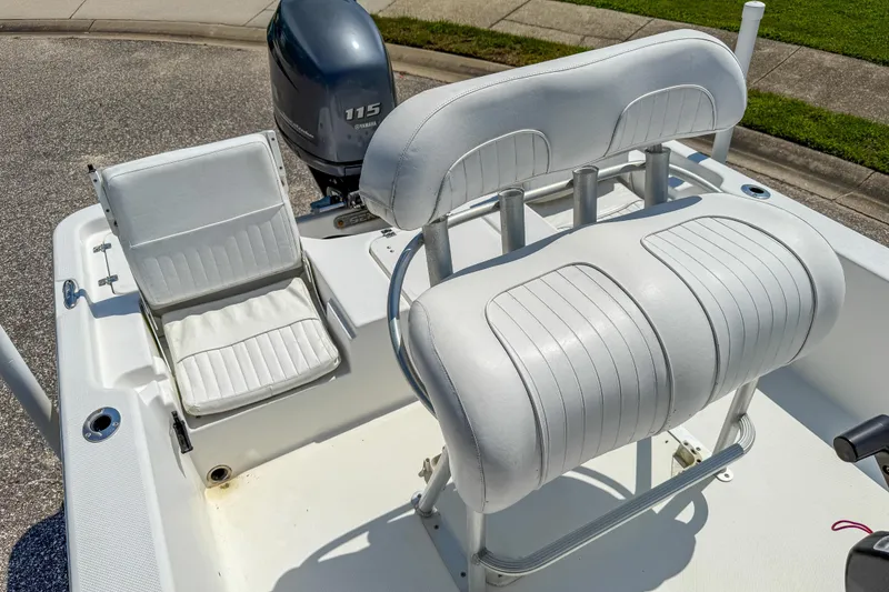 Slide: The Image of 2013 Sea Fox 200XT boat interior with white seating and Yamaha 115 engine. - 21