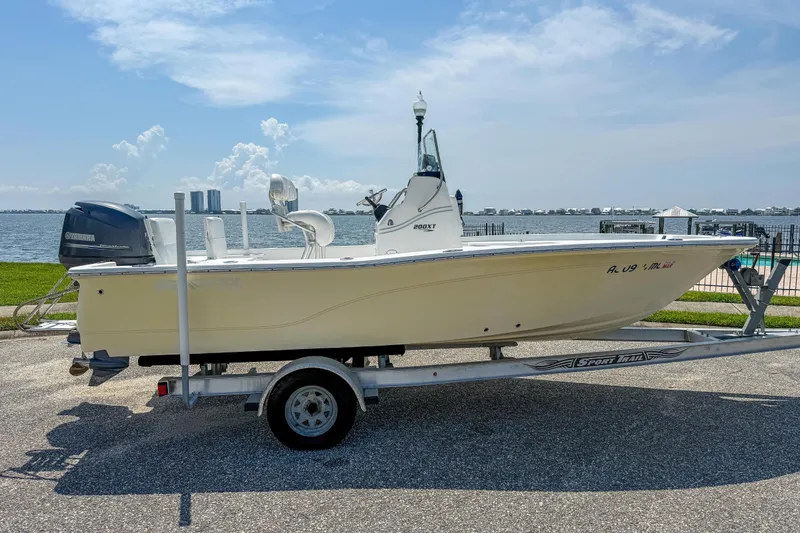 Slide: The Image of 2013 Sea Fox 200XT boat on trailer by waterfront, featuring Yamaha outboard motor. - 6