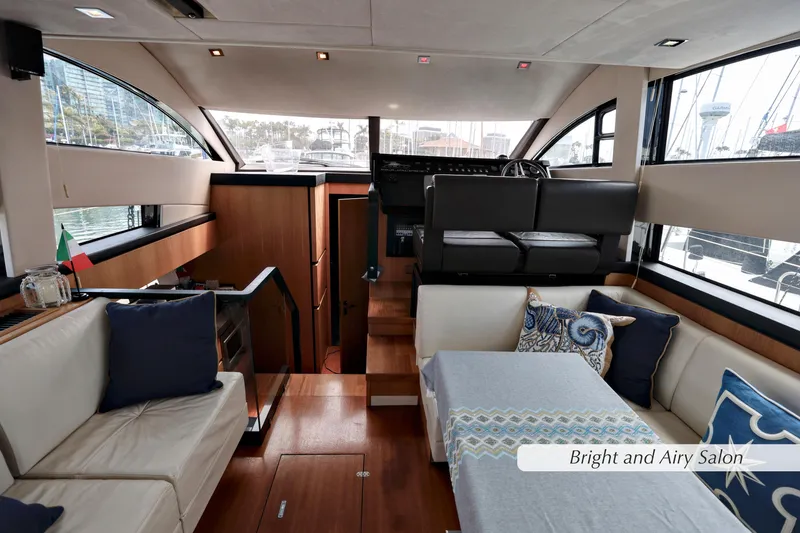 Slide: The Image of Luxurious 2013 Fairline Squadron 42 salon with elegant seating and decorative cushions. - 15