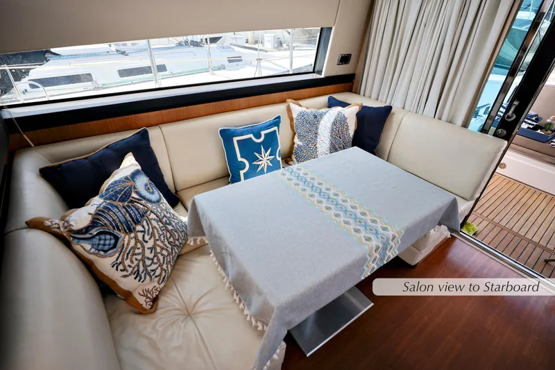 Slide: The Image of 2013 Fairline Squadron 42 yacht salon with white sofa, blue cushions, and nautical decor. - 16