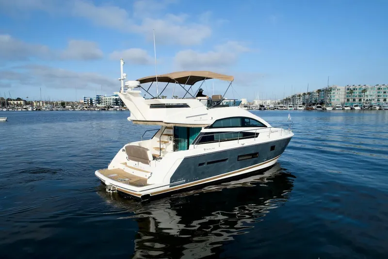 Slide: The Image of 2013 Fairline Squadron 42 yacht cruising on calm waters under a clear sky. - 2