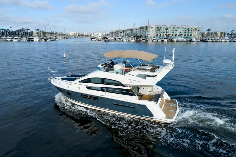 Slide: The Image of 2013 Fairline Squadron 42 yacht on calm water, marina in background. - 4