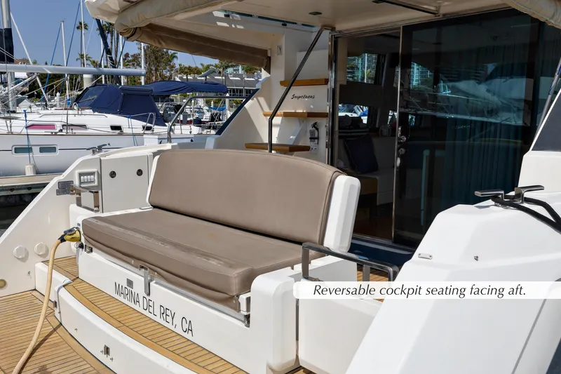 Slide: The Image of 2013 Fairline Squadron 42 yacht with teak deck and cushioned seating at marina. - 7