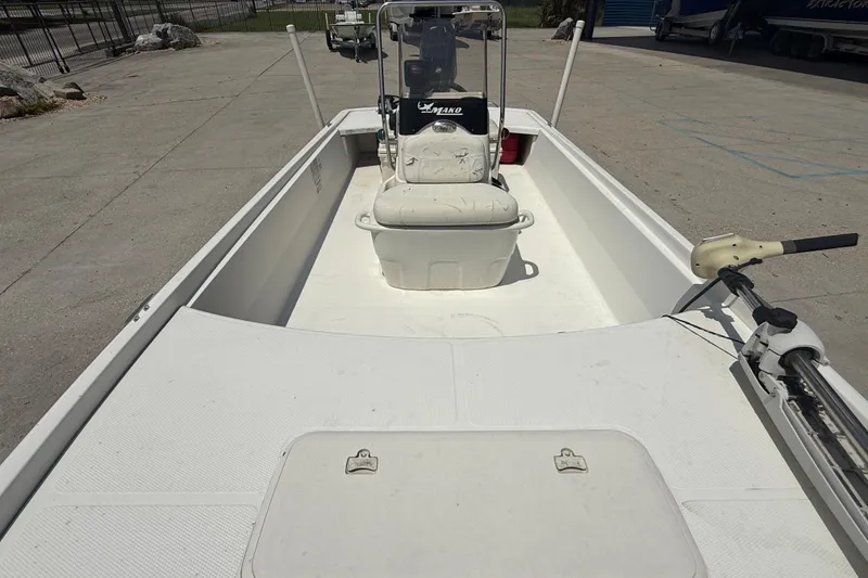 Slide: The Image of 2013 Mako Pro Skiff 17 CC boat, white interior, center console, docked outdoors. - 10